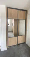 Oak split panel with large mirror centers in a charcoal frame, fitted in Skelton